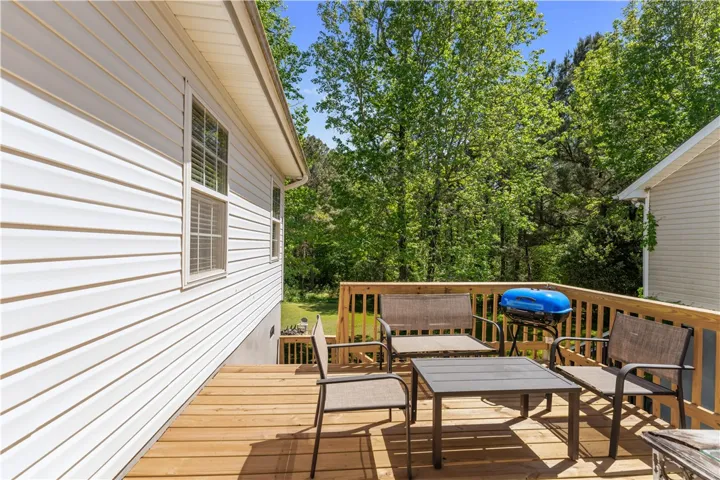 This spacious wooden deck offers an ideal spot for outdoor relaxation and entertaining.