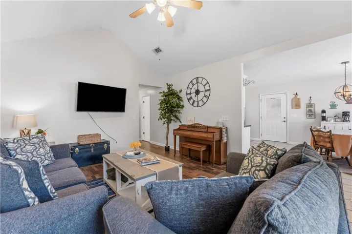 This inviting living space features vaulted ceilings and rich hardwood flooring, perfect for gatherings.