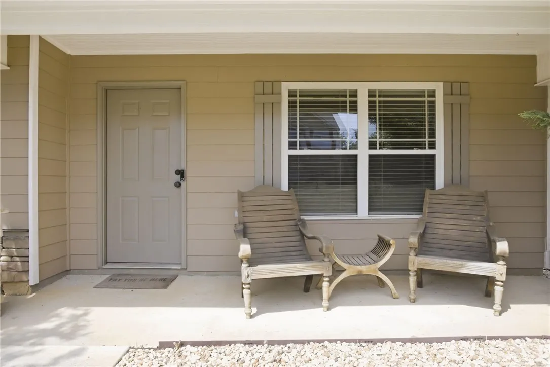 This inviting covered porch provides a charming entrance to the residence.