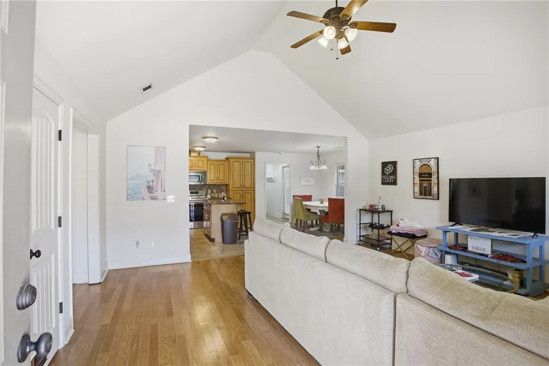 This inviting space features an open layout connecting living, dining, and kitchen areas.