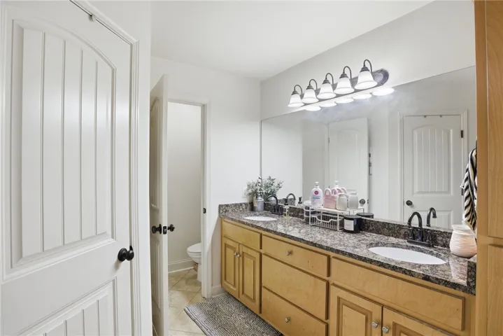 This bathroom features a double vanity with ample counter space and a clean, neutral palette.