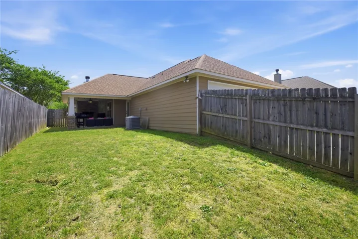 This private yard offers a welcoming patio, perfect for outdoor enjoyment.