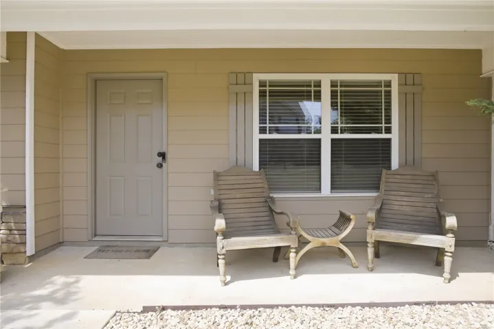 This inviting covered porch provides a charming entrance to the residence.