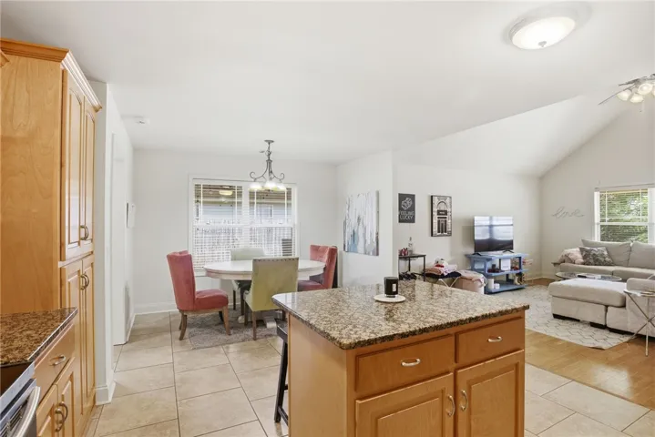 This bright and airy open-concept living space connects the kitchen, dining, and living areas.