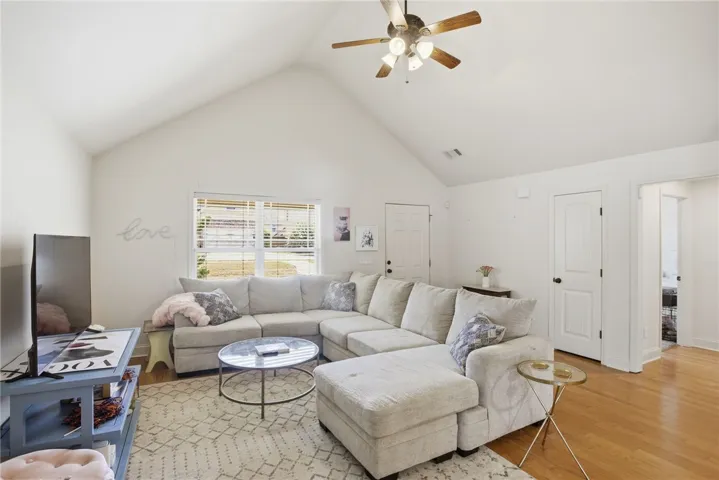This airy living area features vaulted ceilings and ample natural light, perfect for everyday living.