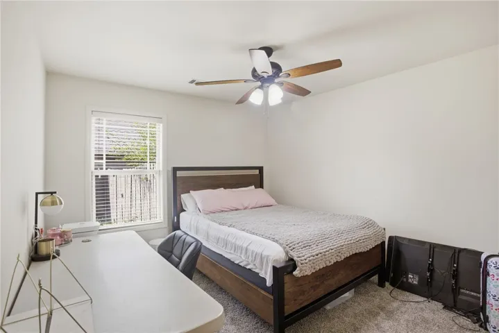 This cozy bedroom provides a comfortable retreat with ample natural light.