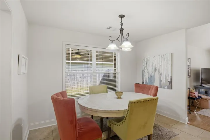 This bright dining area features ample natural light and elegant tile flooring.