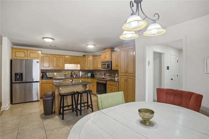 This spacious kitchen offers ample cabinet space and modern appliances, perfect for everyday living and entertaining.