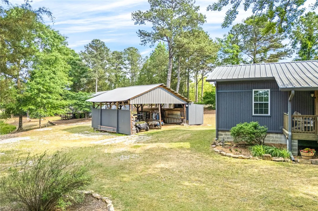 This tranquil setting offers ample space for outdoor equipment, framed by mature trees and lush greenery.