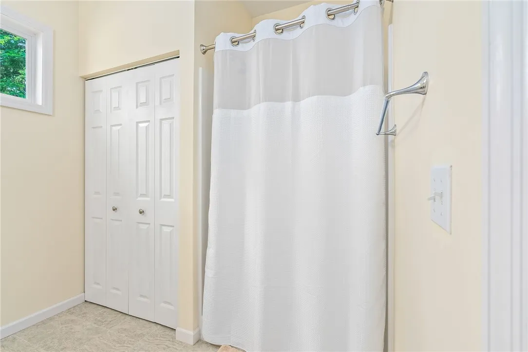This bright bathroom offers ample storage and natural light for comfortable living.