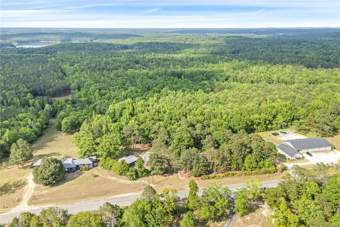 Expansive property with serene lake views amidst lush woodlands.