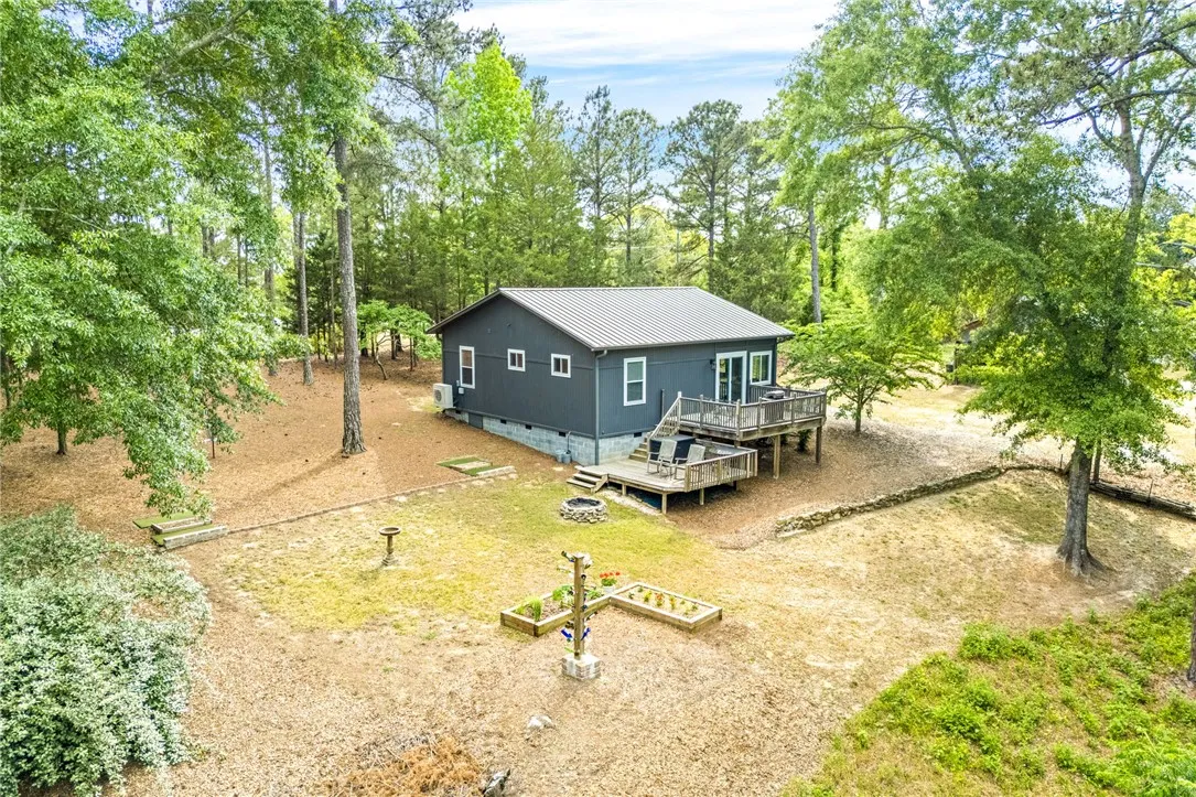 This charming home offers expansive outdoor living with multiple decks, nestled in a serene natural setting.
