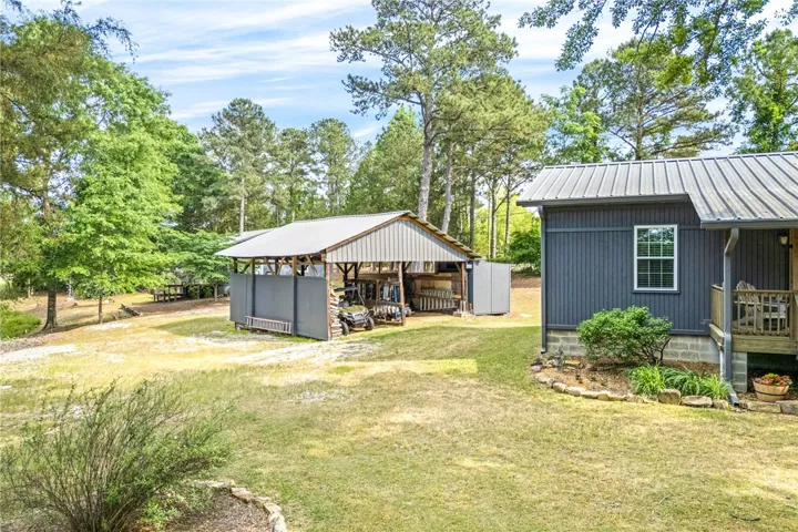 This tranquil setting offers ample space for outdoor equipment, framed by mature trees and lush greenery.