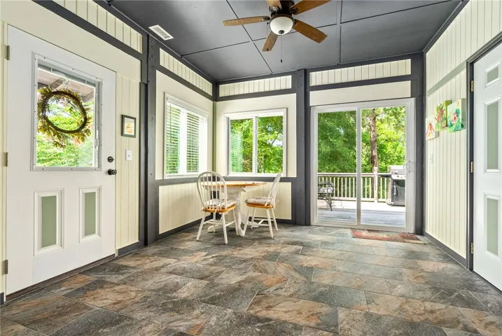 This bright sunroom with tile flooring offers direct access to the outdoors.