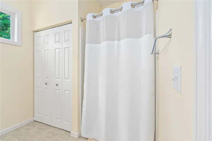This bright bathroom offers ample storage and natural light for comfortable living.