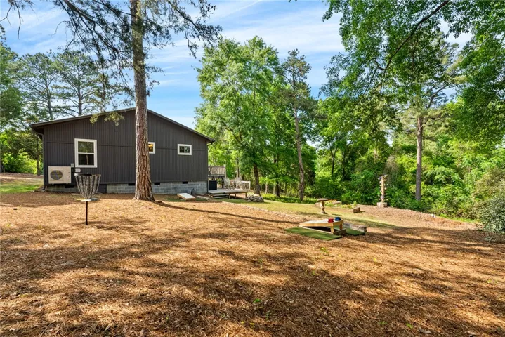 This private backyard offers a relaxing deck with ample space for outdoor activities and serene views.