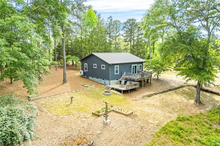 This charming home offers expansive outdoor living with multiple decks, nestled in a serene natural setting.