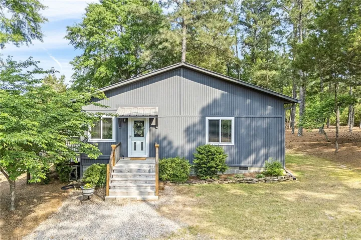 This inviting home offers charming curb appeal with lush greenery and a welcoming entrance.
