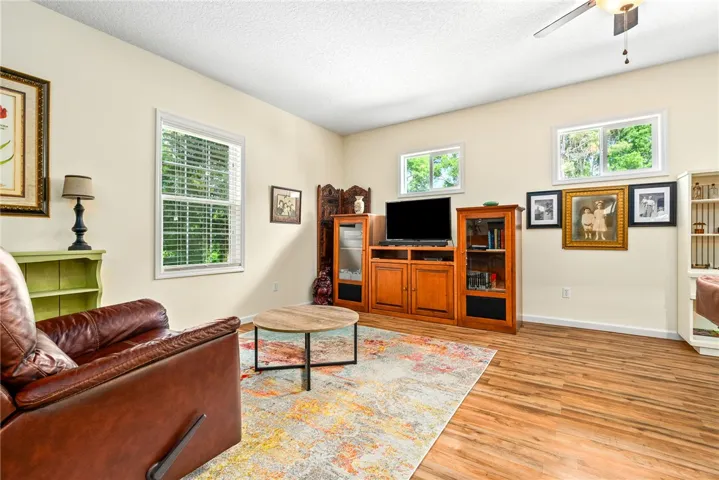 Bright and inviting living space with warm wood flooring and ample natural light.