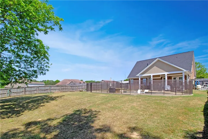 This spacious backyard offers a perfect setting for outdoor enjoyment and relaxation.