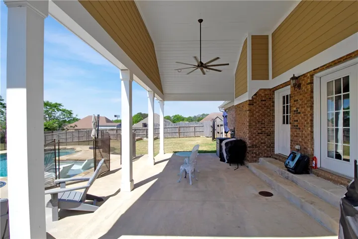 This spacious patio offers an inviting outdoor living area for relaxation and entertaining.