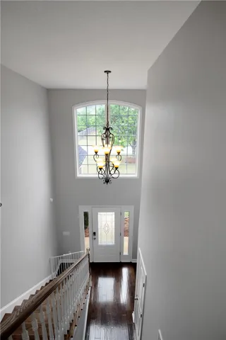 This grand foyer welcomes with soaring ceilings and abundant natural light.