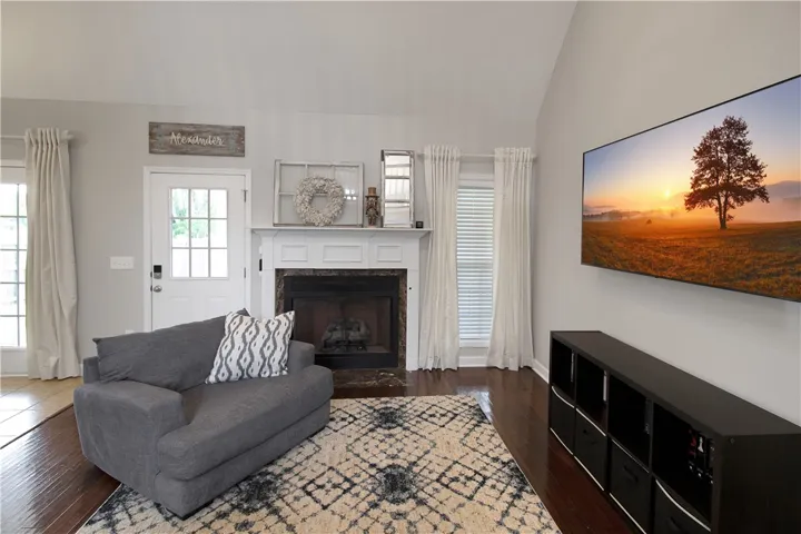 This living area features a warm fireplace, rich hardwood floors, and abundant natural light.