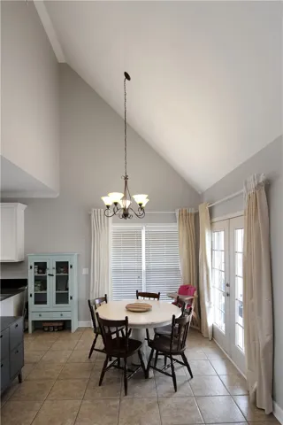 This dining area features lofty vaulted ceilings, creating an airy and bright atmosphere.