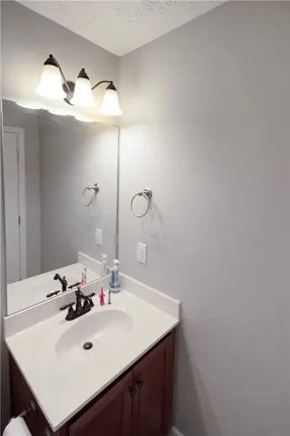This bathroom features a contemporary vanity with a spacious countertop and sleek fixtures.