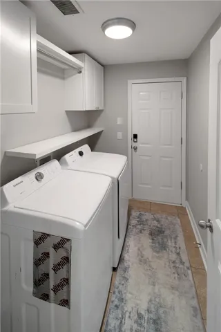 This dedicated laundry space offers practical convenience with essential appliances and clever storage solutions.