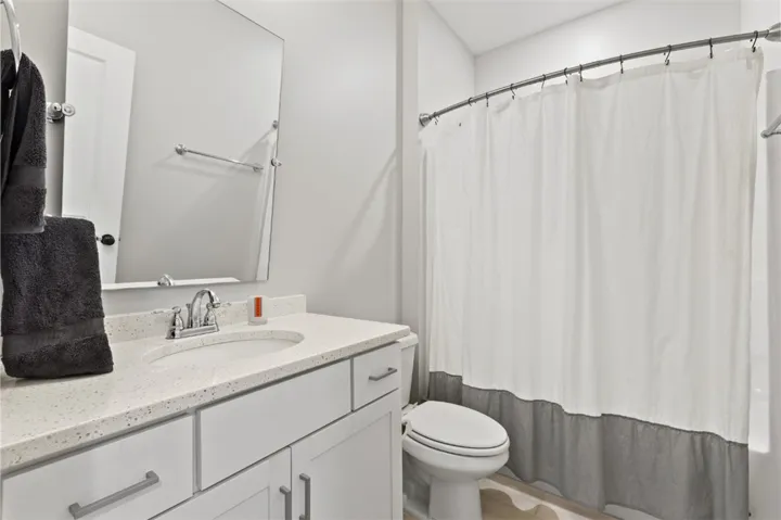 Full bath serves the adjacent bedroom and guests