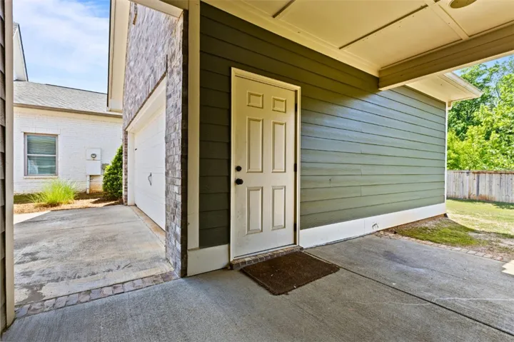 back porch provides covered access to the detached two-car