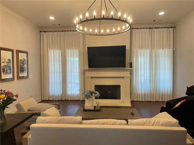 This living area features rich hardwood flooring and a classic fireplace, perfect for relaxation.