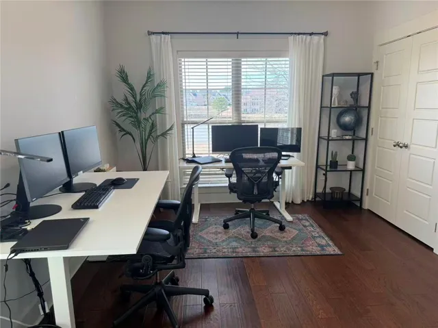 This dedicated home office offers rich wood floors and ample natural light, perfect for productivity.