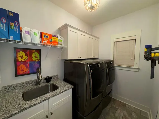 This dedicated space offers practicality with integrated storage and a convenient utility sink.