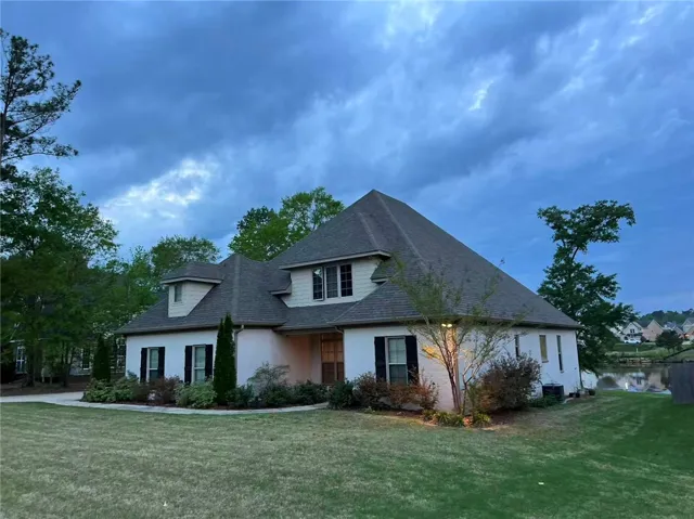This charming residence offers serene water views and classic architectural details.