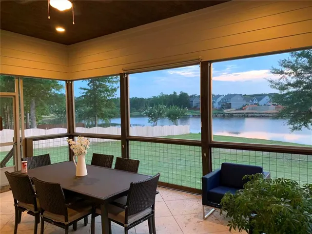 This screened patio offers serene lakeside views, ideal for quiet relaxation.