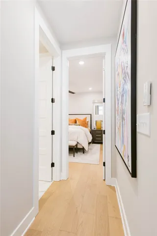 This inviting hallway offers a seamless transition to a bright and comfortable bedroom retreat.