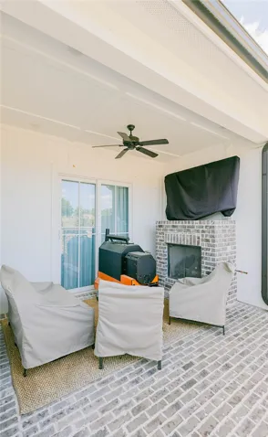 This inviting outdoor patio space offers relaxation and entertainment with a charming fireplace and ample seating.