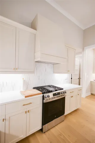 This bright kitchen features sleek appliances, ample counter space, and warm wood flooring.