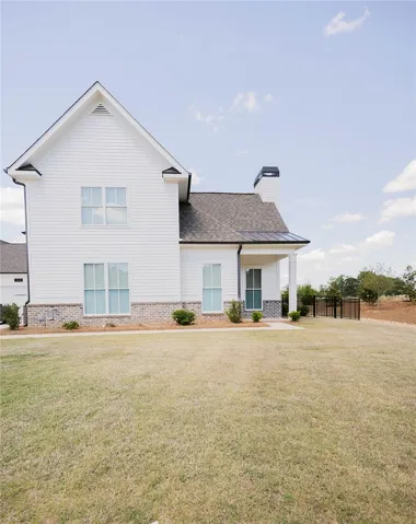 This bright residence features a classic gable roofline and an inviting covered porch.