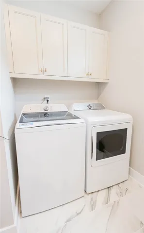 A well-appointed laundry area offers practicality and ample storage for daily chores.