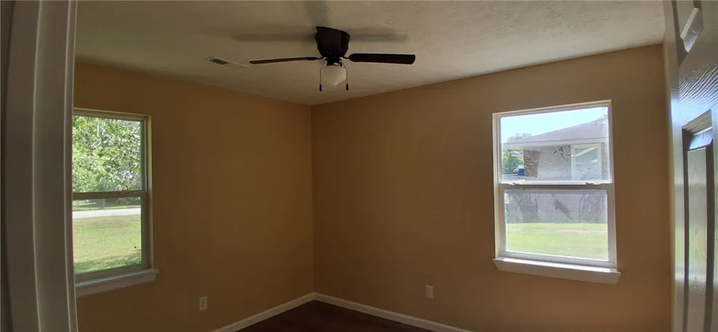 This bedroom  with overhead fan, perfect for relaxation.