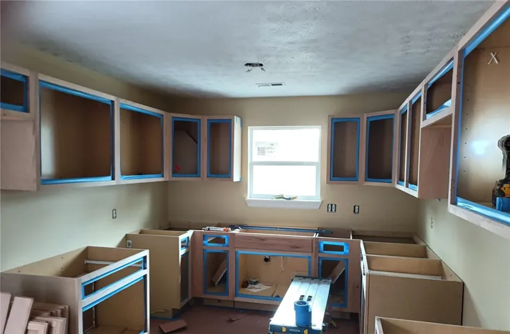 This spacious kitchen offers ample cabinetry, ready for your custom finishes and culinary creations.