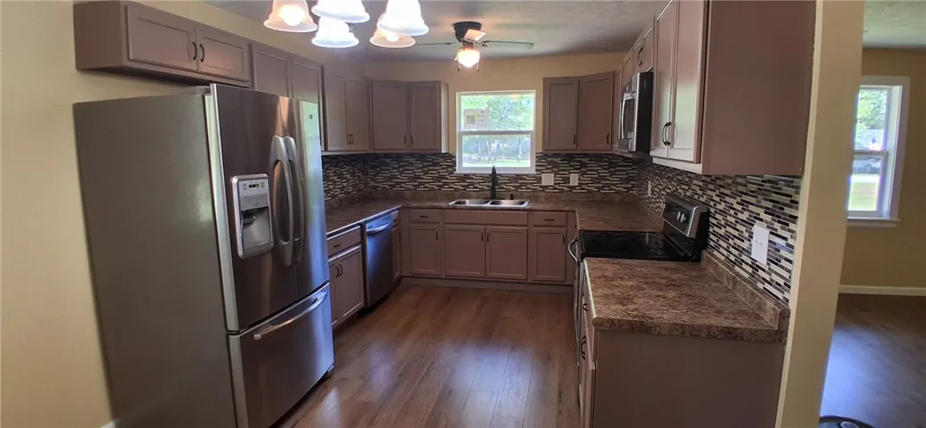 This kitchen features sleek countertops, modern cabinetry, and durable flooring, creating an inviting culinary space.