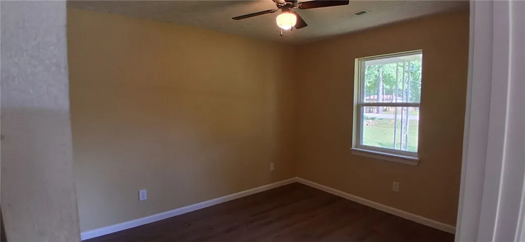 This  bedroom  with overhead fan, perfect for relaxation.