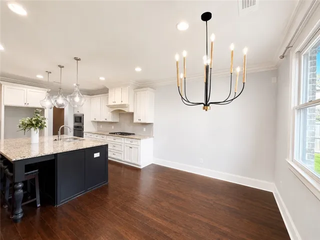 A well-appointed kitchen features rich hardwood flooring and sleek, modern fixtures for comfortable living.