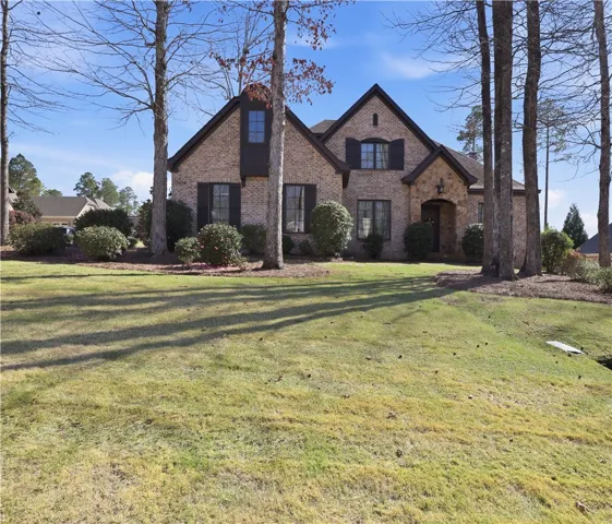 An inviting facade featuring brick and stone accents promises warmth and elegance.