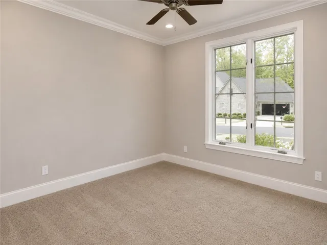 A well-lit room offers a comfortable atmosphere with a view of the neighborhood.