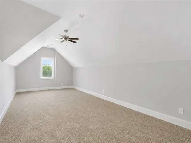 Sloping ceilings define this versatile attic space, offering potential for a personalized retreat.